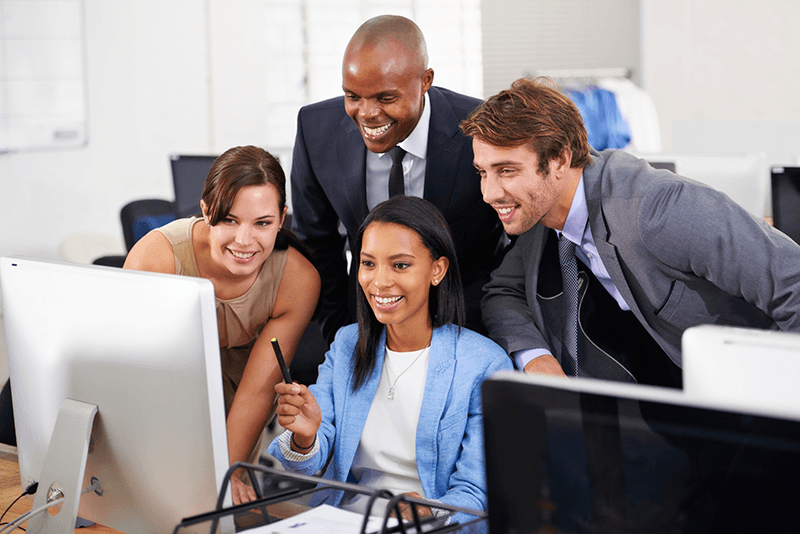 Four Ontario Insurance Brokers reviewing a Commercial Insurance claim on a computer - D.G. Bevan 